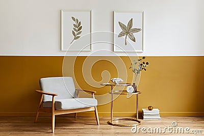 Unique living room in modern style interior with design armchair, elegant gold coffee table, mock up poster frames. Stock Photo