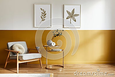 Unique living room in modern style interior with design armchair, elegant gold coffee table, mock up poster frames, flowers. Stock Photo