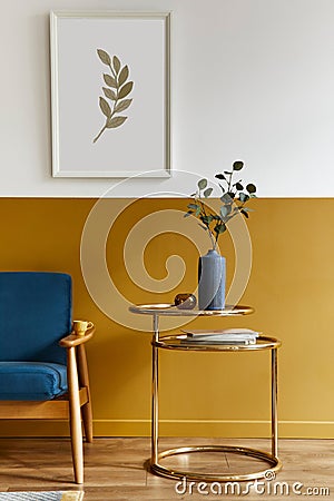 Unique living room in modern style interior with design sofa, elegant gold coffee table, mock up poster frames, flowers in vase. Stock Photo