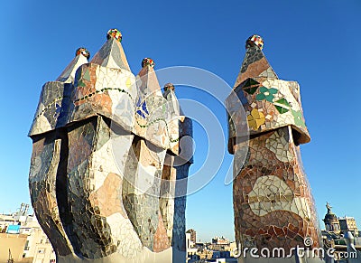 Unique mosaic chimneys against the vibrant blue sky of Barcelona Editorial Stock Photo