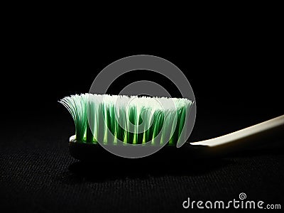 A unique picture of a toothbrush under dark background Stock Photo