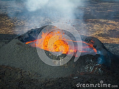 Erupted volcano and surroundings, boiling lava flowing, pull away drone shot Stock Photo