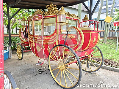 a unique and vintage photo of the royal golden train of Indonesian history in red in the garden taken in the afternoon Stock Photo