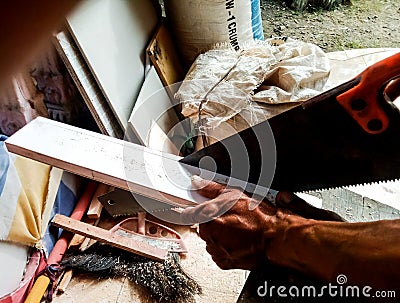 Modern sawing with manual saw Stock Photo