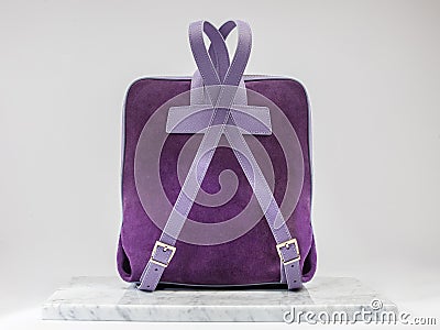 Unisex backbag. Luxury, purple leather and suet backbag on white background, on marble floor Stock Photo