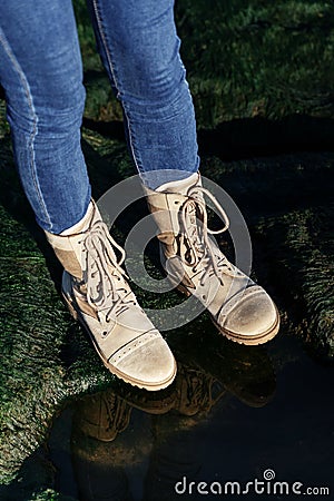 Unisex jeans and beige khaki boots on green nature background Stock Photo