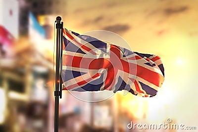 United Kingdom Flag Against City Blurred Background At Sunrise B Stock Photo