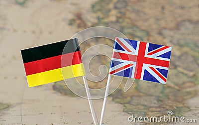 The United Kingdom and Germany flag pins on a world map background, political relations concept Stock Photo