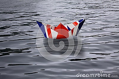 United Kingdom sailing alone in the sea like a paper ship made as the English flag Union Jack - Brexit concept showing England lea Stock Photo