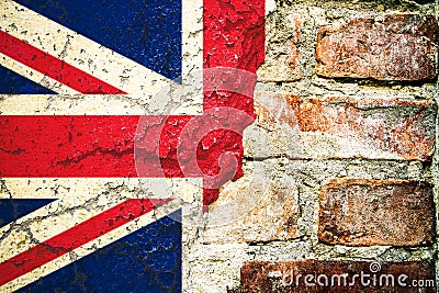 Brexit: United Kingdom UK flag flag painted cracked divided peeling paint brick wall cement facade Brexit concept. Stock Photo