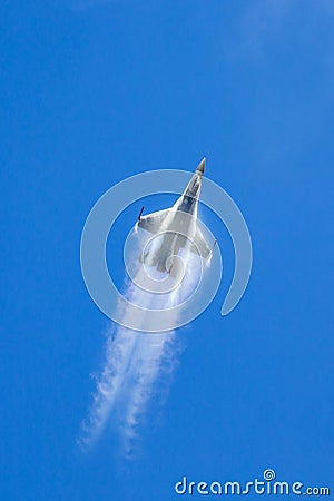 United Staes Air Force USAF Lockheed F-16CJ fighter aircraft climbing vertically with vapor pouring off the wings Editorial Stock Photo