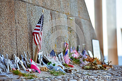 United States and Canadian flags, flowers and objects in memory of fallen in Normandy landing. Editorial Stock Photo