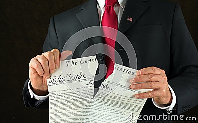 United States politician ripping up and shredding The Constitution representing corruption and injustice Stock Photo