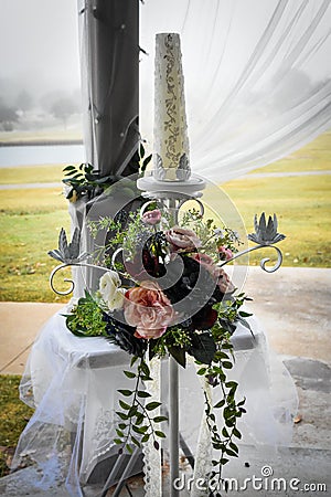 Unity Candle with flowers at an Outdoor Wedding Stock Photo