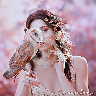 Unity with nature, portrait photography of cute girl with fair skin and wild owl Stock Photo