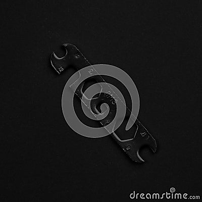 Universal black & white wrench isolated on black background Stock Photo