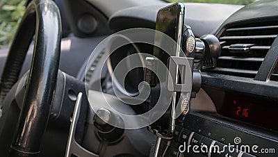 Universal mount holder for smart phones or tablet. Car dashboard or wind-shield holder bracket for mobile phone Stock Photo