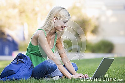 University student using laptop outside Stock Photo