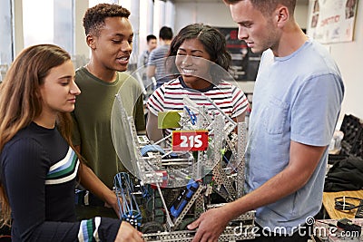 University Students Carrying Machine In Science Robotics Or Engineering Class Stock Photo