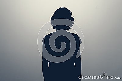 Unknown female person silhouette in studio. Concept of depression Stock Photo