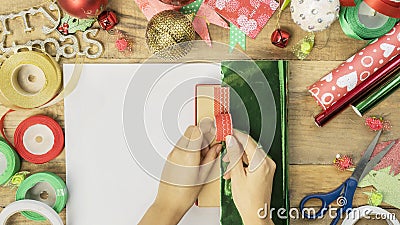 Unknown female prepare to wrap a Christmas gift Stock Photo