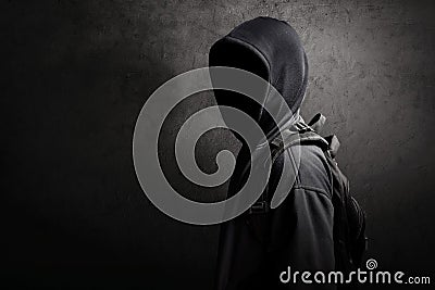 Unknown hacker standing on the street Stock Photo