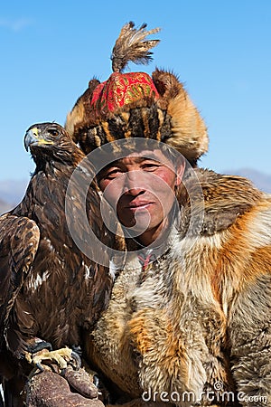 Unknown huntsman shows his Golden Eagle that is trained for falconry. Editorial Stock Photo