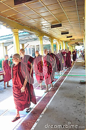 Unknown monks walking at the temple of Shwethalyaung Reclining B Editorial Stock Photo