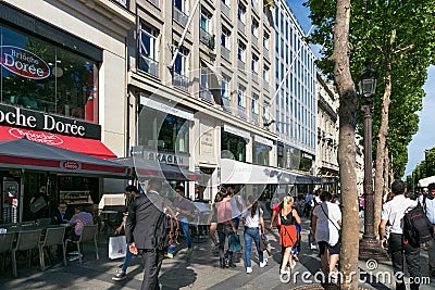 PARIS, FRANCE - JUNE 23, 2017: Unknown people walking in the center of Paris on the Avenue des Champs-Elysees Editorial Stock Photo