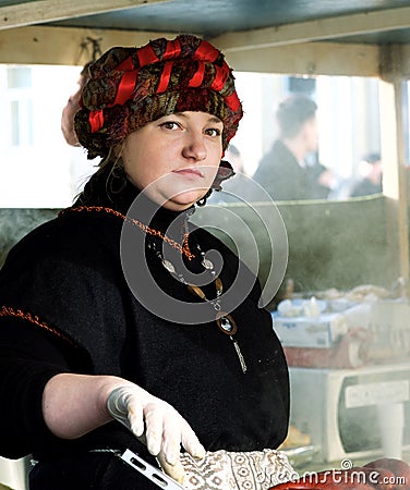 Unknown person in traditional flea market cooking in street kitchen on Feb 7, 2016 in Vilnius, Lithuania Editorial Stock Photo