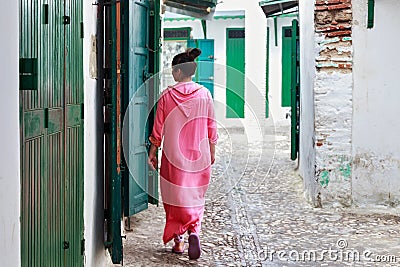 Unknown woman in national clothes on the old street in Tetouan Medina quarter in Northern Morocco. A medina is typically walled, Editorial Stock Photo