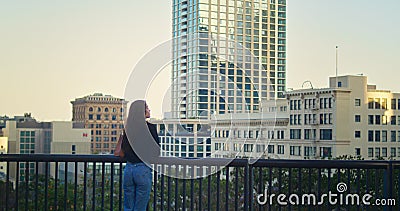 Unknown young lady walking on observation deck. Stylish tourist looking on town. Stock Photo