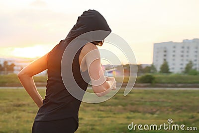 Unknown young woman running at the stadium outdoor Stock Photo