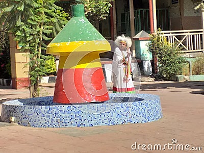 Unkown old lady walking in the compound of old historical hotel in Addis Ababa Editorial Stock Photo