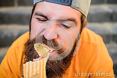 Unleashed appetite. Street food concept. Man bearded eat tasty sausage. Urban lifestyle nutrition. Carefree hipster eat Stock Photo