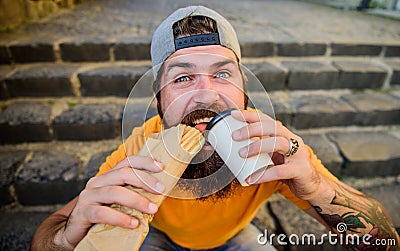 Unleashed appetite. Street food concept. Man bearded eat tasty sausage. Urban lifestyle nutrition. Junk food. Carefree Stock Photo