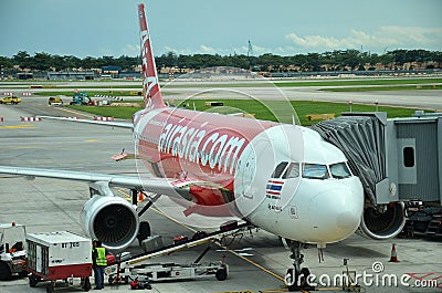 Unloading of baggage from the Air Asia aircraft Editorial Stock Photo