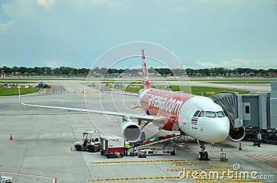 Unloading of baggage from the Air Asia aircraft Editorial Stock Photo
