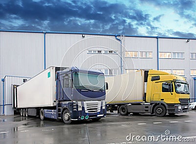 Unloading cargo truck at warehouse building Stock Photo
