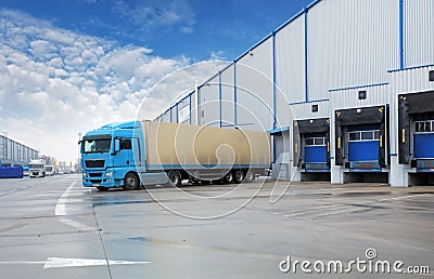 Unloading cargo truck at warehouse building Stock Photo