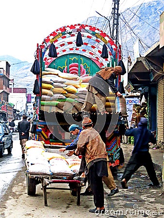 unloading a truck in the streets of Gilgit, district capital of Gilgit-Baltistan, Pakistan Editorial Stock Photo