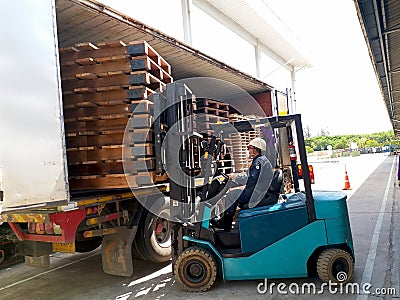 Unloading wood pallet by forklift. Editorial Stock Photo