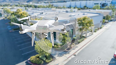 Unmanned Aircraft System Quadcopter Drone In The Air Near Corporate Industrial Building Stock Photo