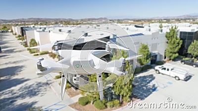 Unmanned Aircraft System Quadcopter Drone In The Air Near Corporate Industrial Building Stock Photo