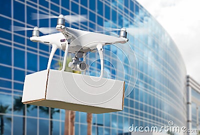 Unmanned Aircraft System UAS Quadcopter Drone Carrying Blank Package Stock Photo