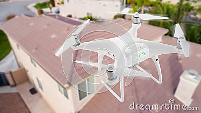 Unmanned Aircraft System UAV Quadcopter Drone In The Air Over Stock Photo