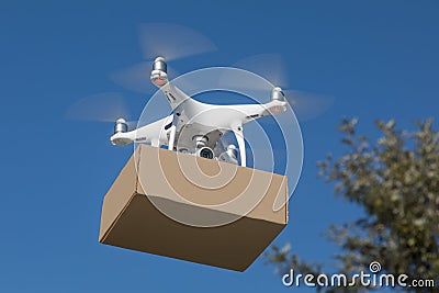 Unmanned Aircraft System UAV Quadcopter Drone Delivering Package Stock Photo