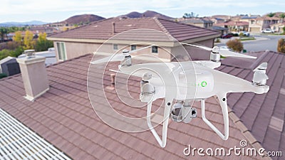 Unmanned Aircraft System UAV Quadcopter Drone Over Homes Stock Photo