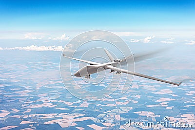 Unmanned military aircraft flies high in the sky at high speed over fields, blue sky clouds Stock Photo