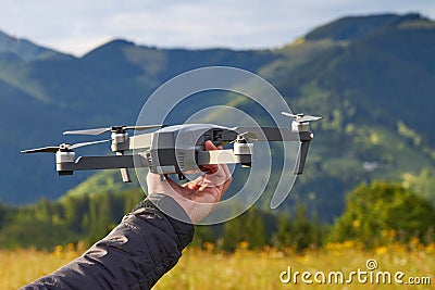 Unmanned quad with a digital camera, a tourist holds in his hand Stock Photo